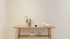 A simple resin table ornament sitting elegantly on a minimalist wooden desk.