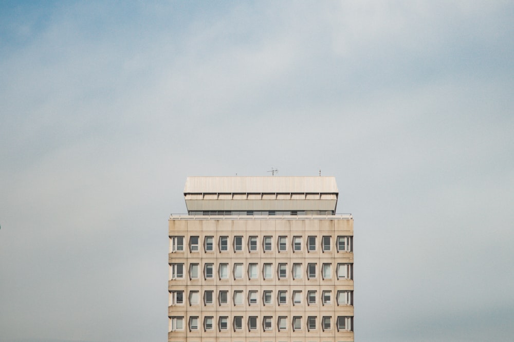 beige concrete building under gray sky
