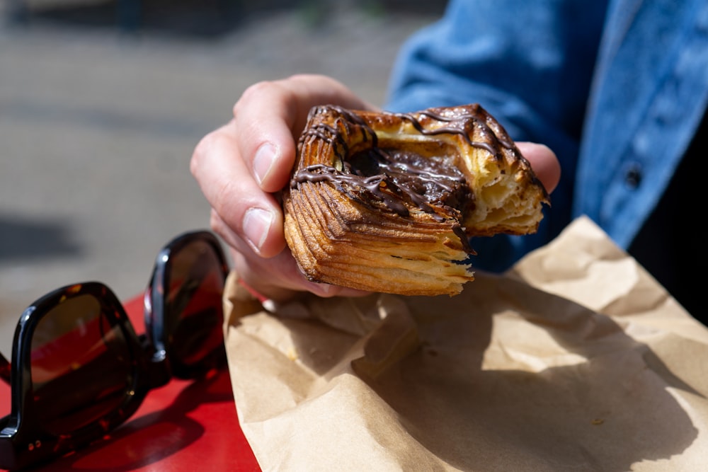 person holding brown and black chocolate