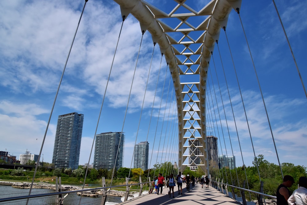 people walking on gray concrete bridge during daytime