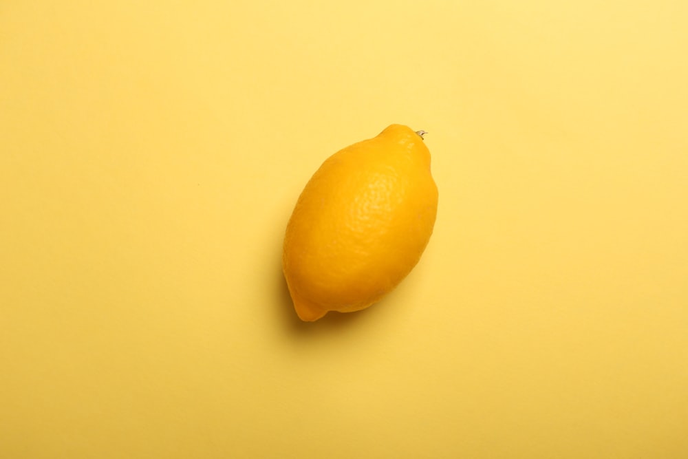 yellow lemon fruit on yellow surface