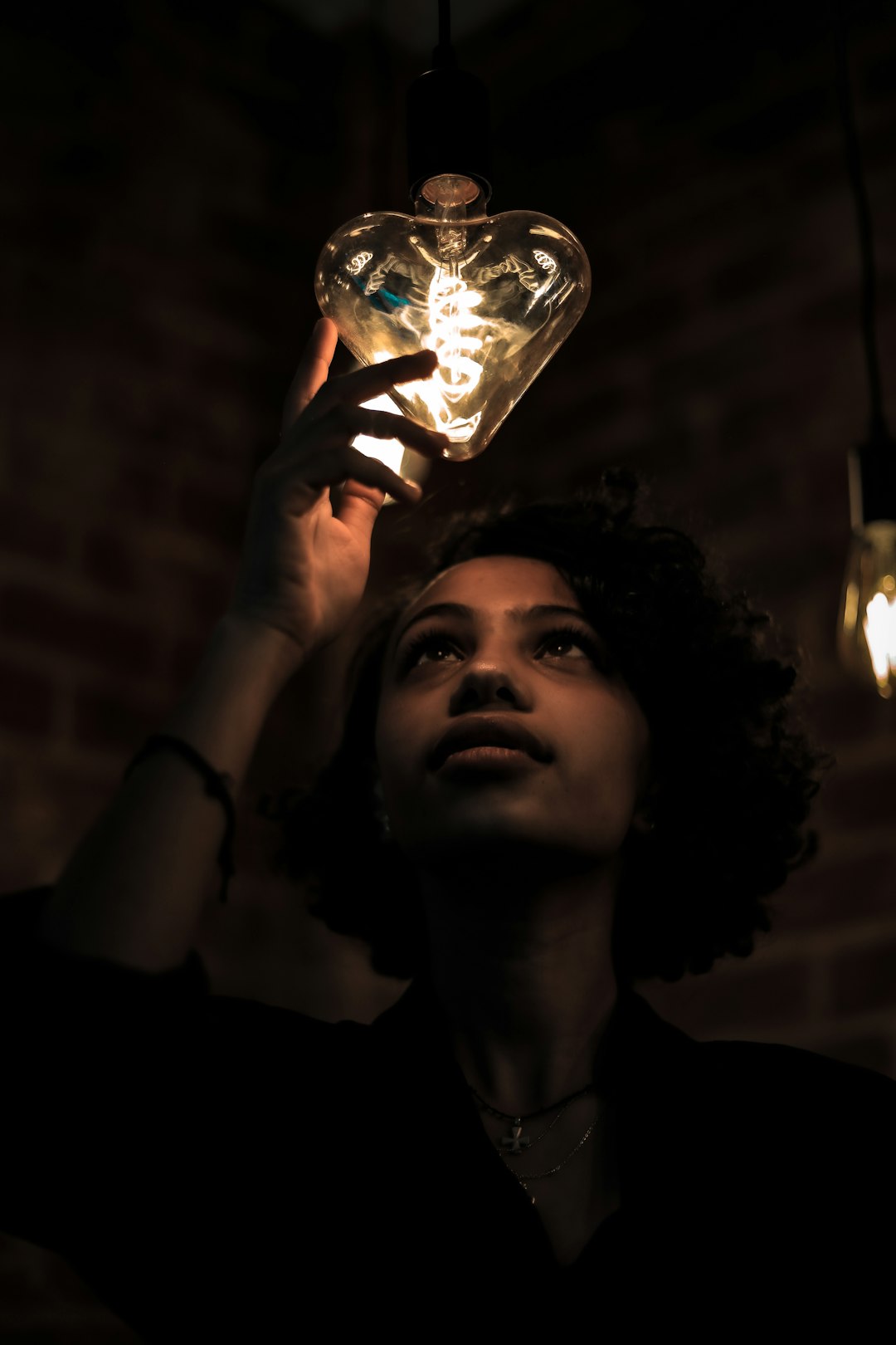 woman in black shirt holding clear glass jar