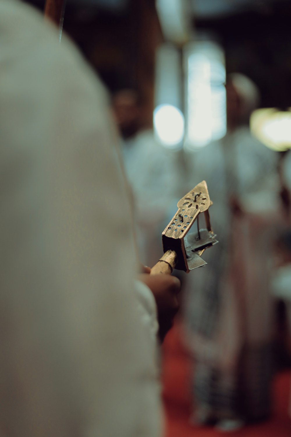 brown wooden cross ornament in tilt shift lens