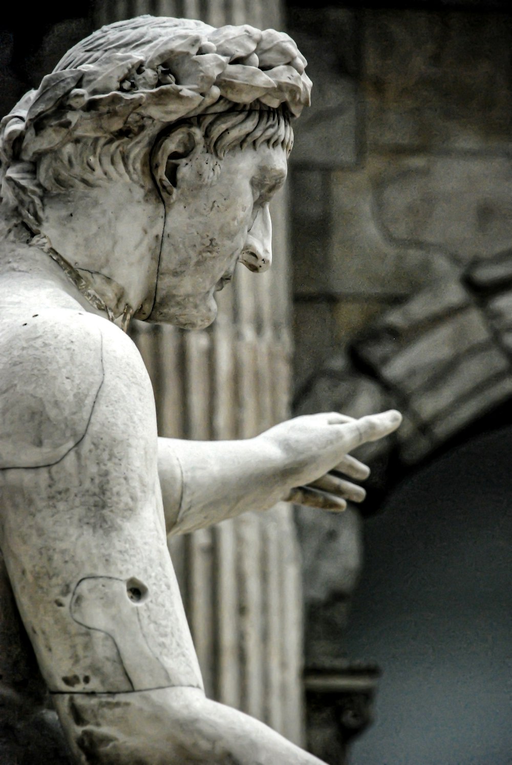 man holding a bird statue