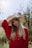 woman in red long sleeve shirt wearing brown fedora hat