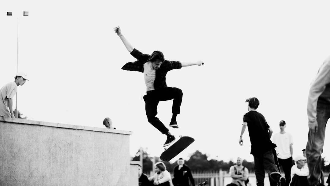 man in black jacket and pants doing skateboard stunts