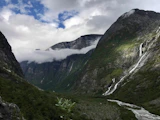 green and gray mountains under white clouds during daytime