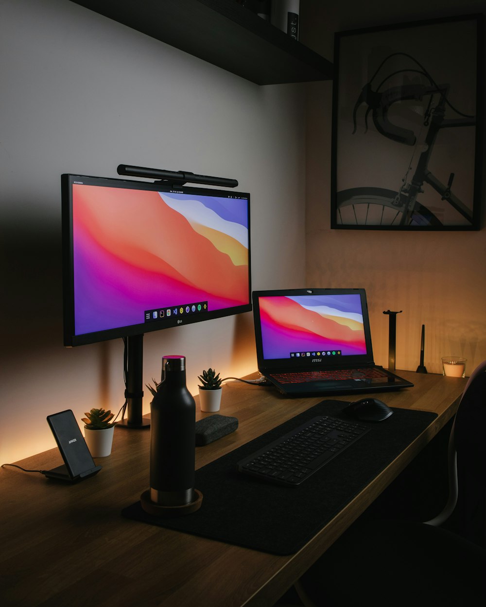 black flat screen computer monitor on brown wooden desk