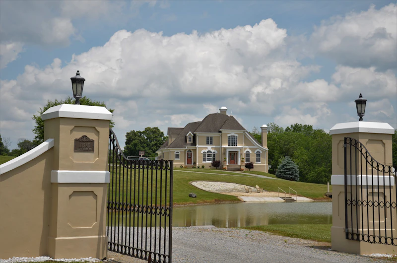 Grand estate entrance gate flanked by stone pillars
