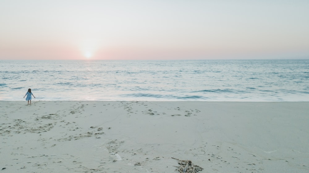 white sand beach during sunset