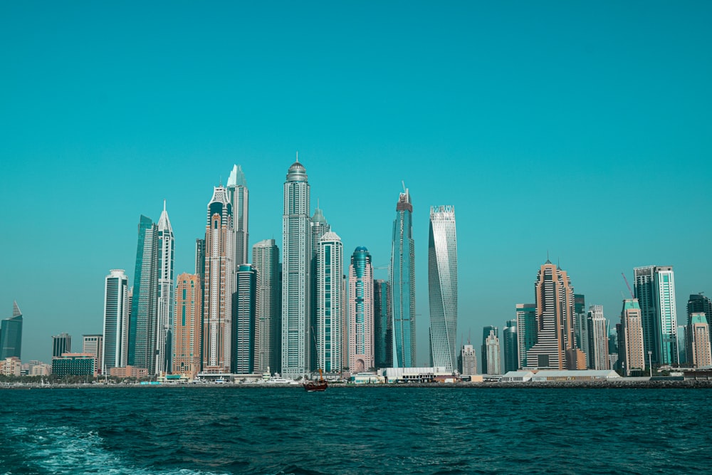 city skyline across body of water during daytime