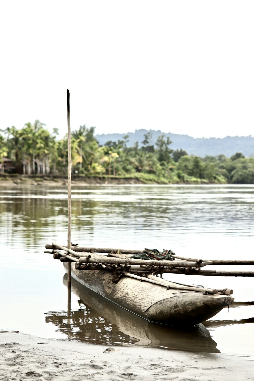 brown wooden boat on lake during daytime