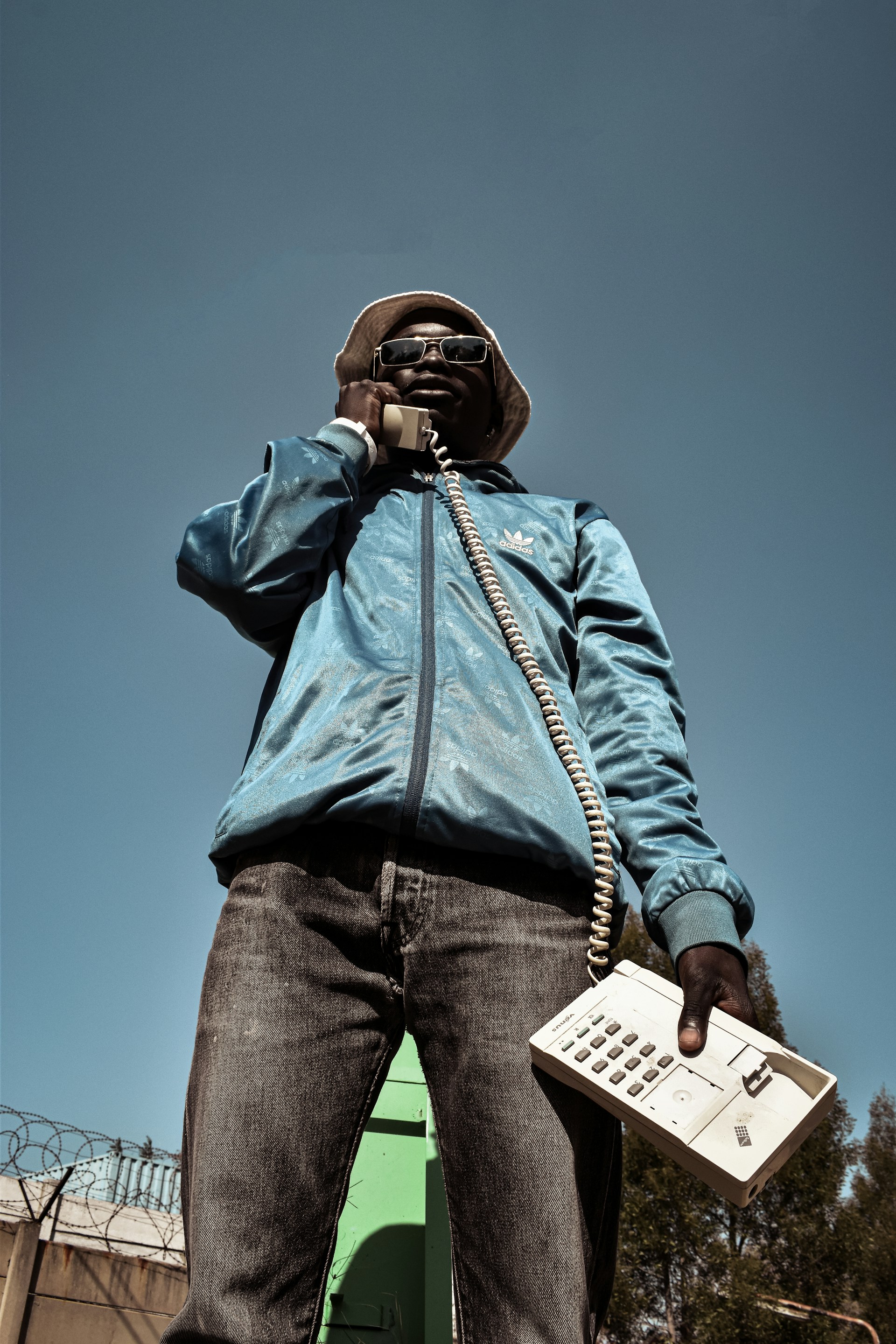 man in blue jacket and blue denim jeans wearing black headphones