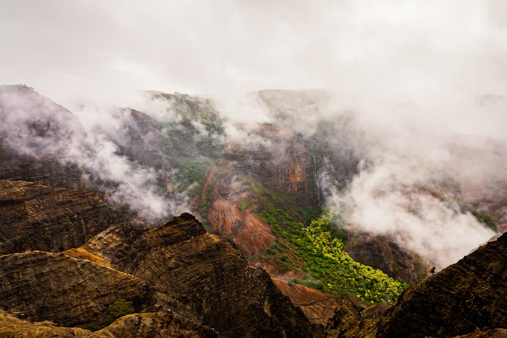 green and brown mountain under white clouds during daytime