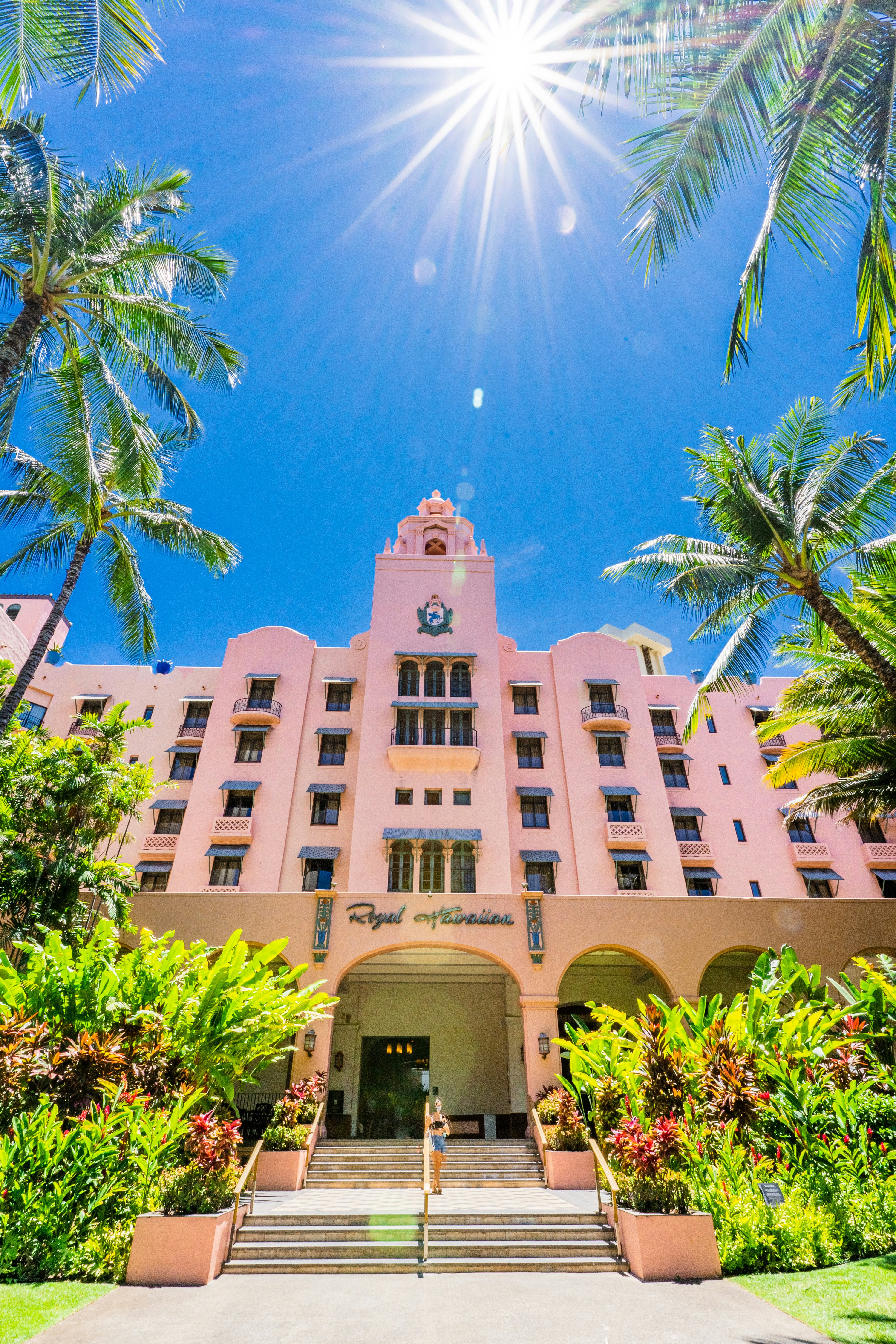 beige concrete building near palm trees during daytime