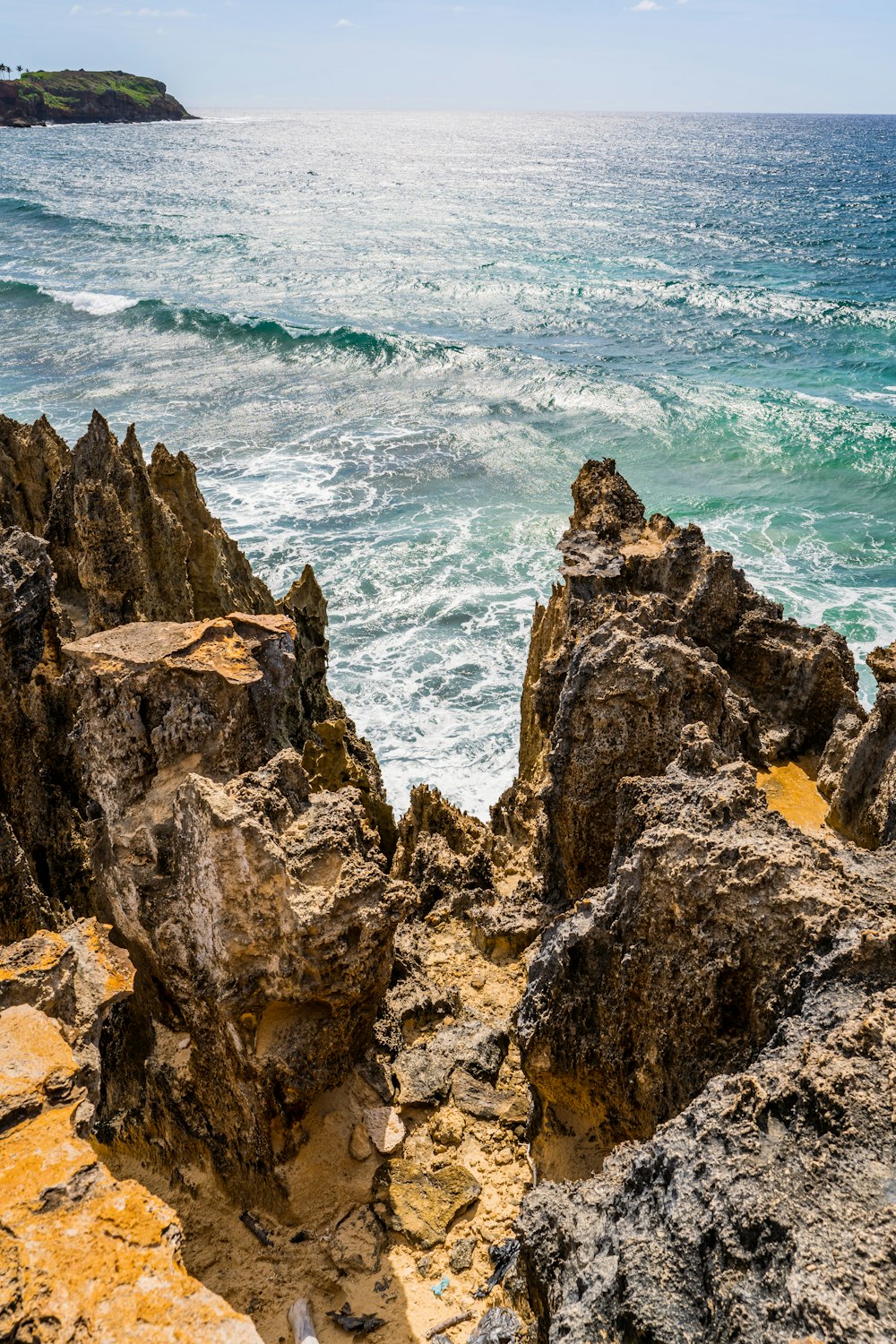 brown rock formation near body of water during daytime