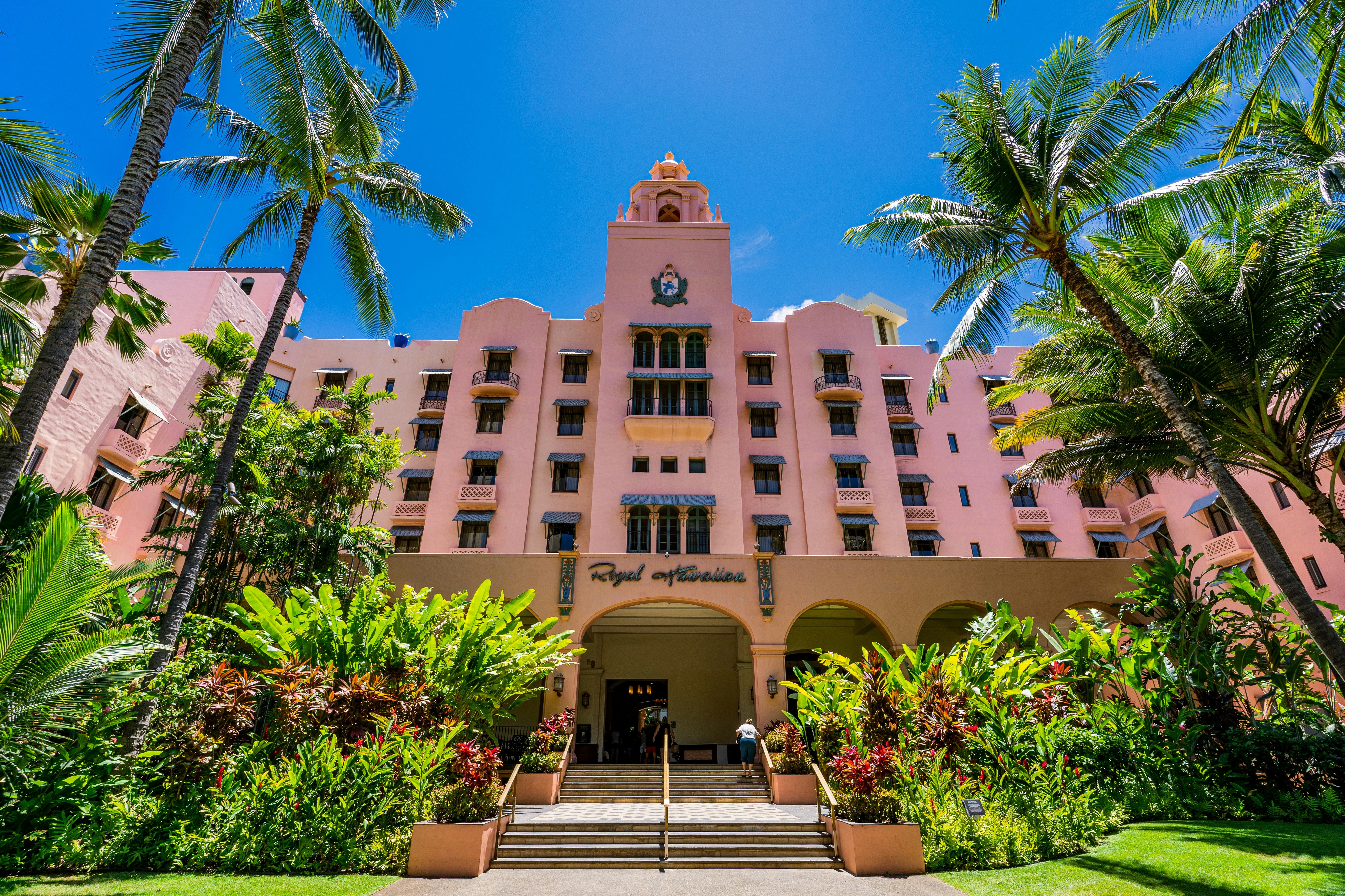 brown concrete building near green trees during daytime, 