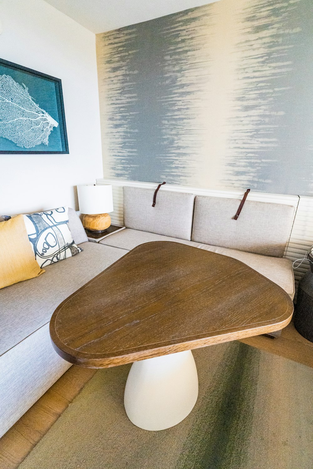 brown wooden oval table near white sofa