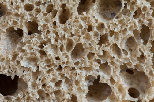 Close-up of a dental implant surface showing its porous texture under laboratory lighting.
