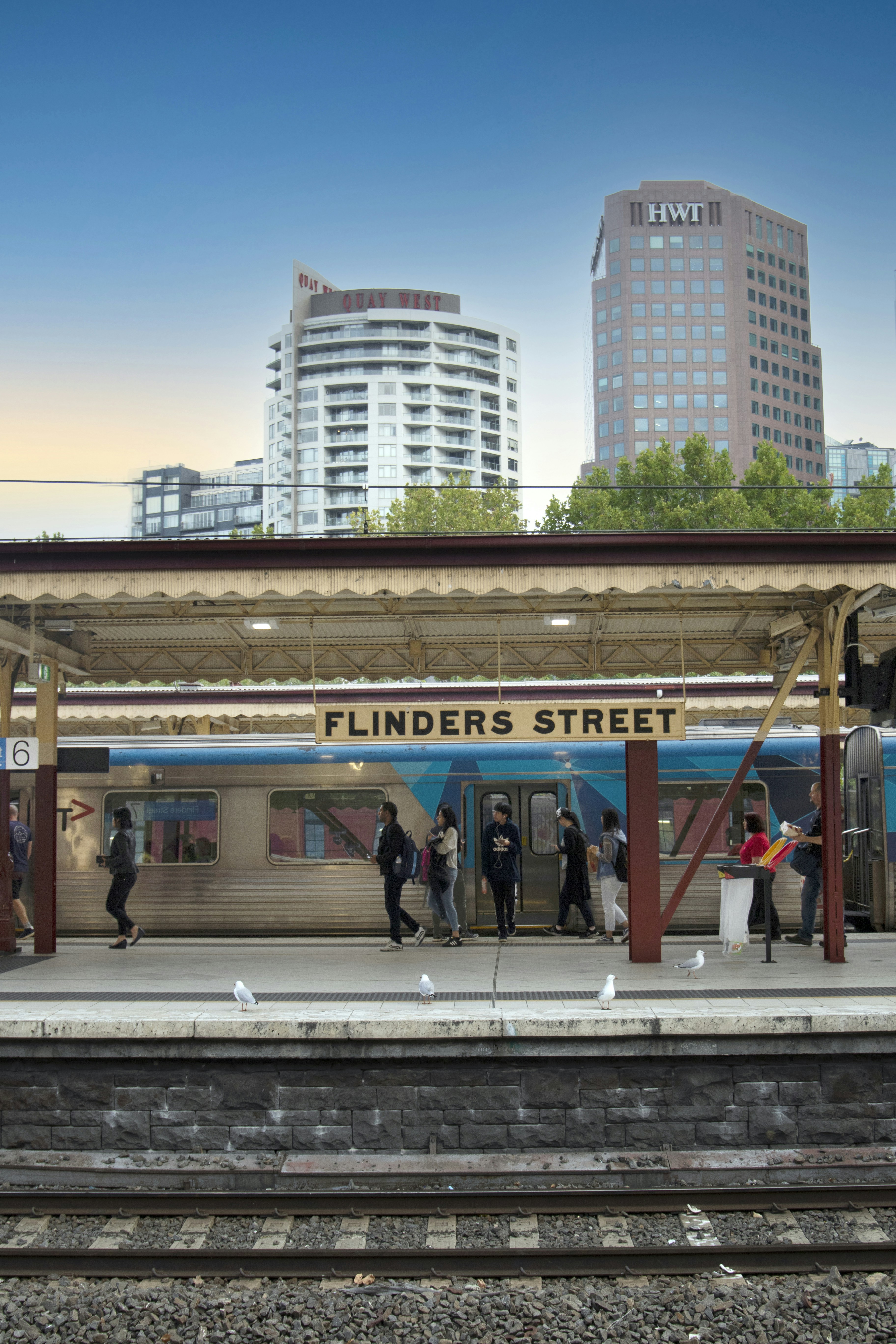 people walking on sidewalk near building during daytime