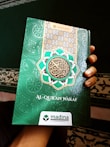 A compact pocket-sized Quran for easy carrying.