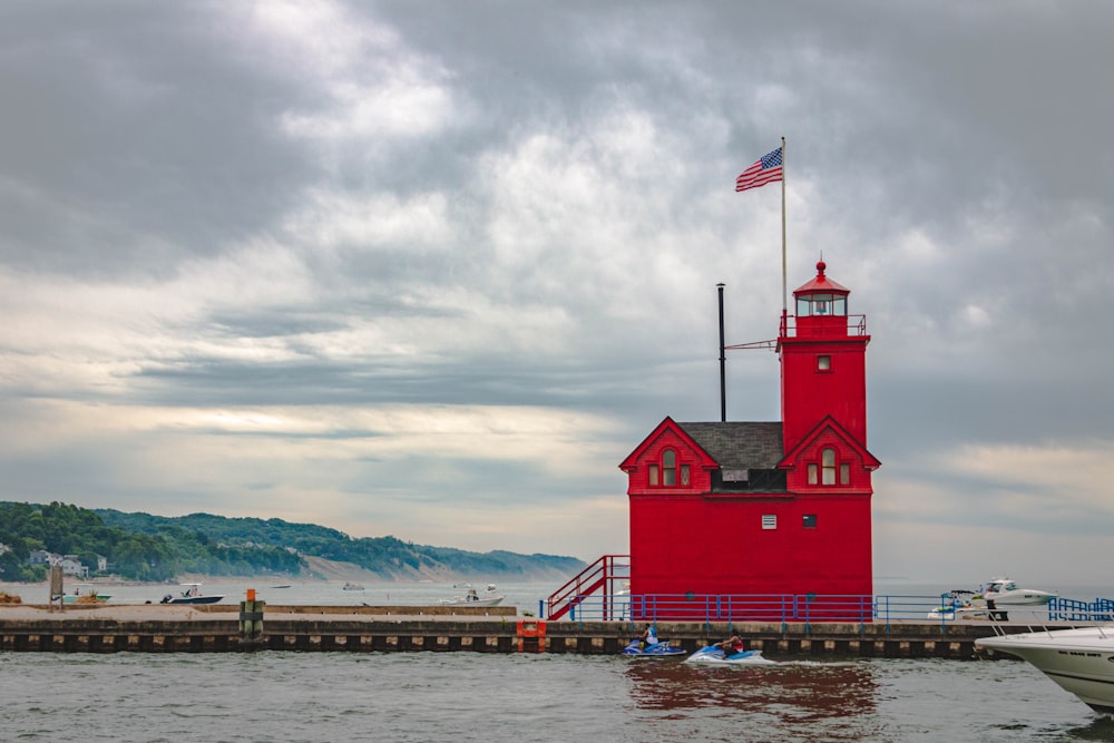 red and white house near body of water during daytime