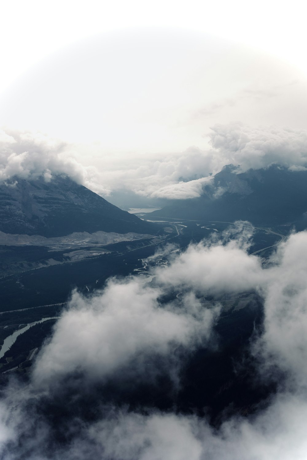 white clouds over snow covered mountains