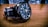 A close-up of an elegant watch with intricate detailing on a wooden surface.