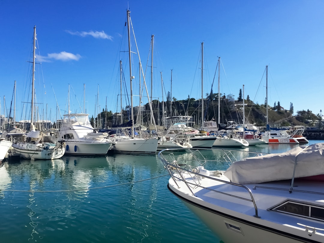 white and blue boats on sea under blue sky during daytime