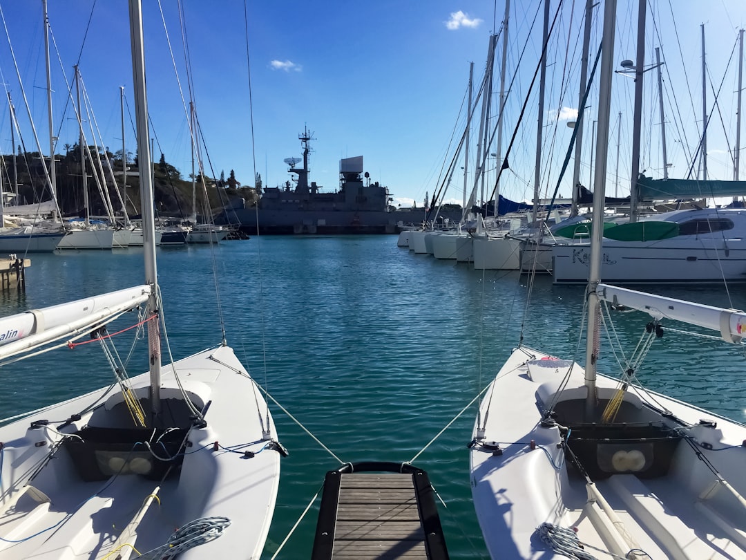 white and black boat on sea dock during daytime