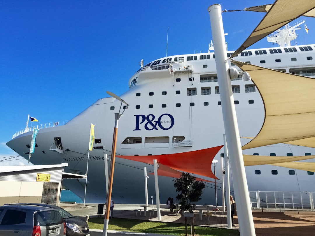 white and orange ship on dock during daytime