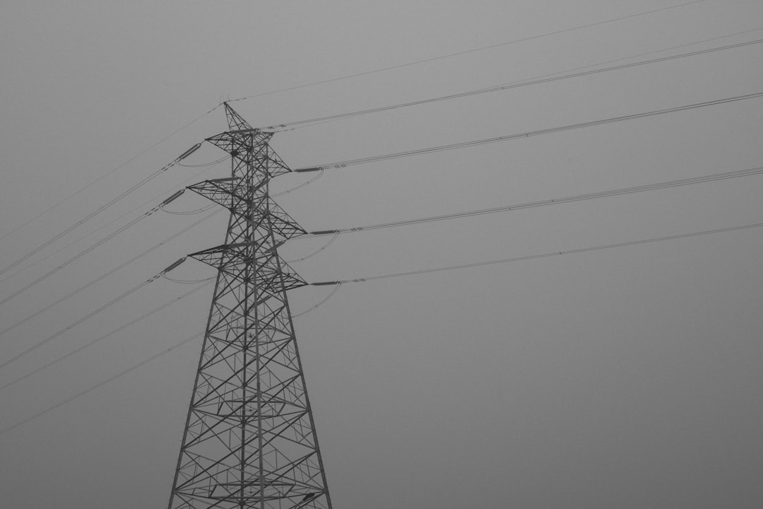 black electric tower under gray sky