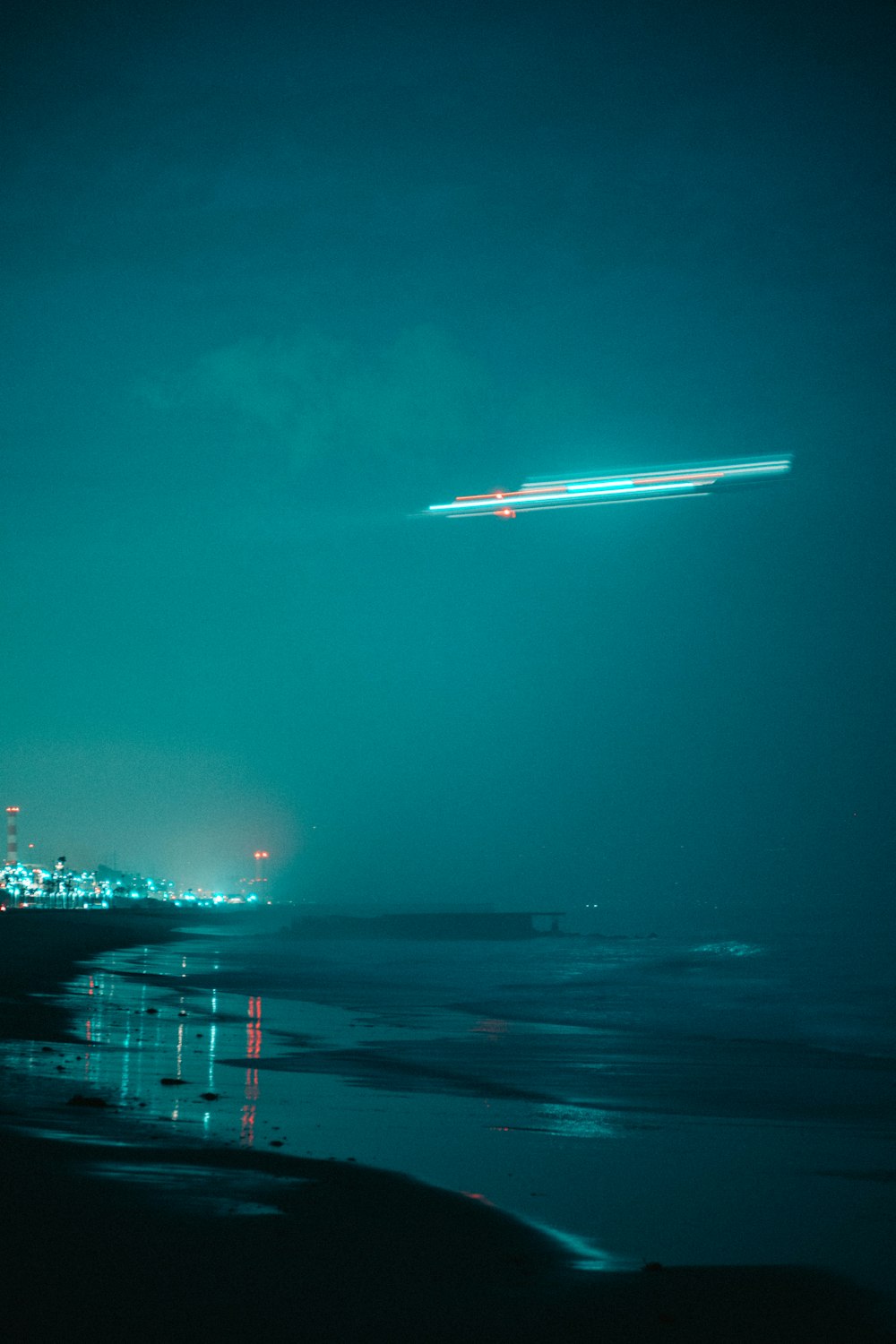 white and blue ship on sea during night time