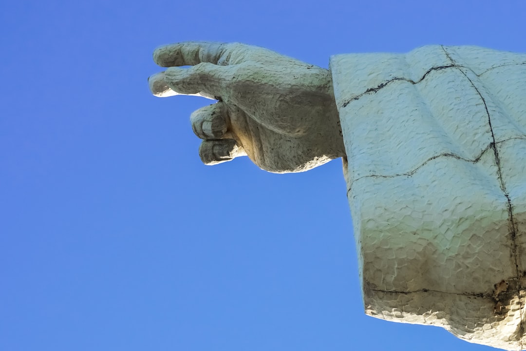 person holding gray concrete wall