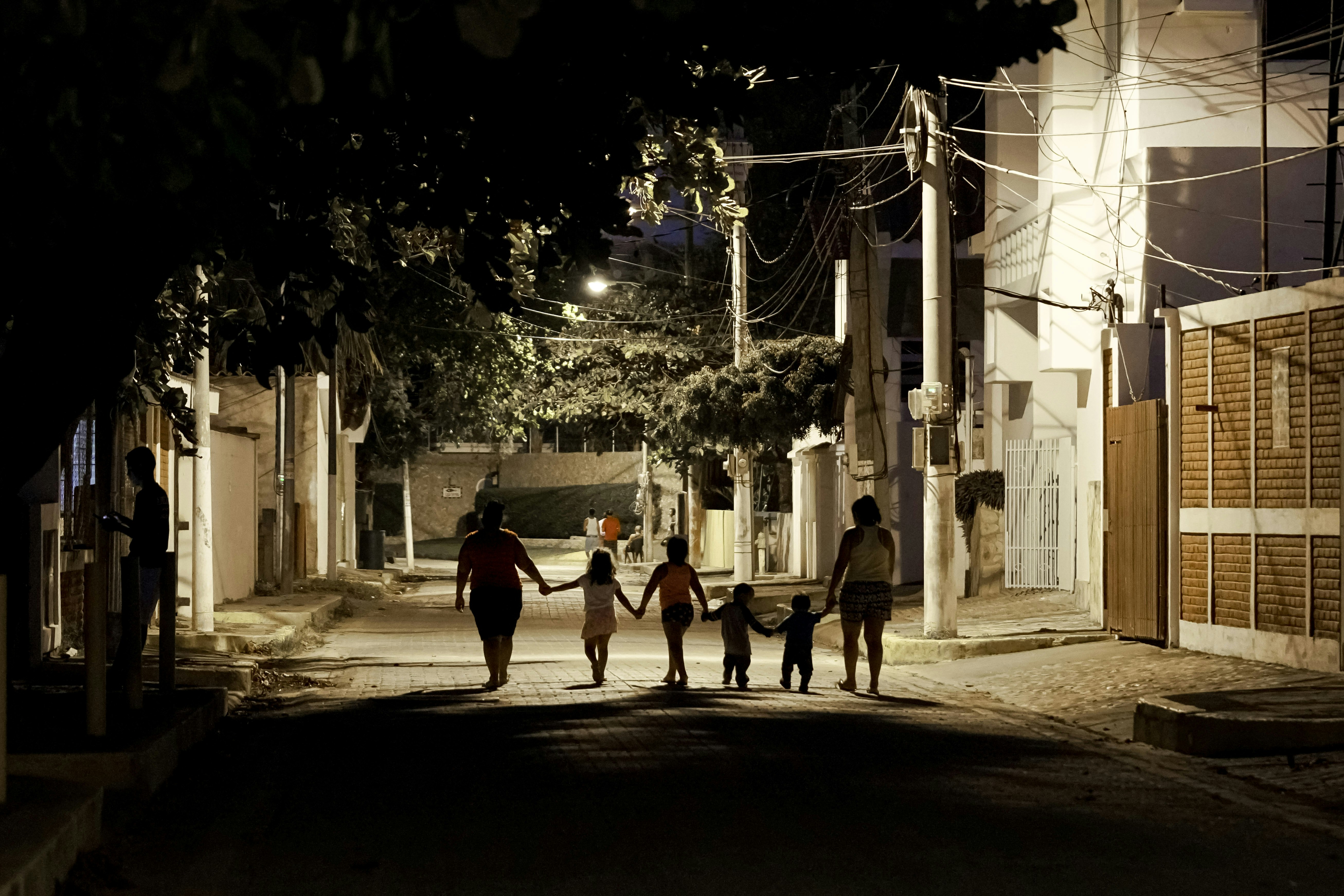 people walking on street during night time