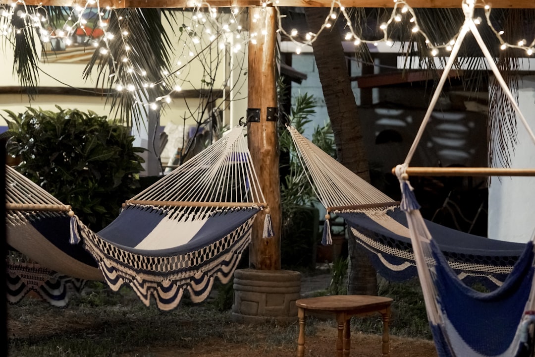 blue and white hammock near brown wooden table