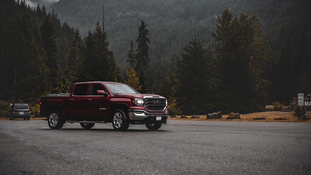 red chevrolet crew cab pickup truck on road during daytime