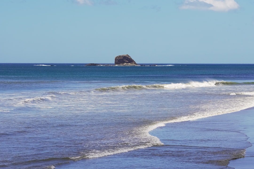 brown rock formation on sea during daytime