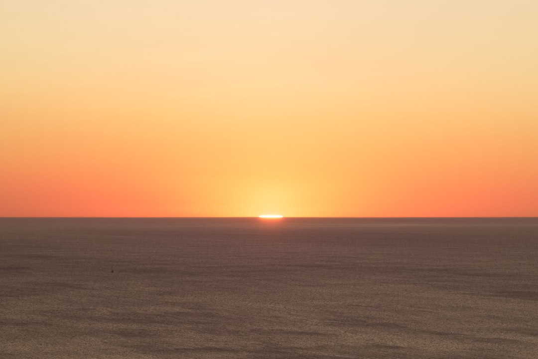 body of water during sunset