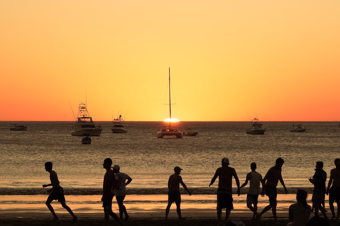 silhouette of people on beach during sunset