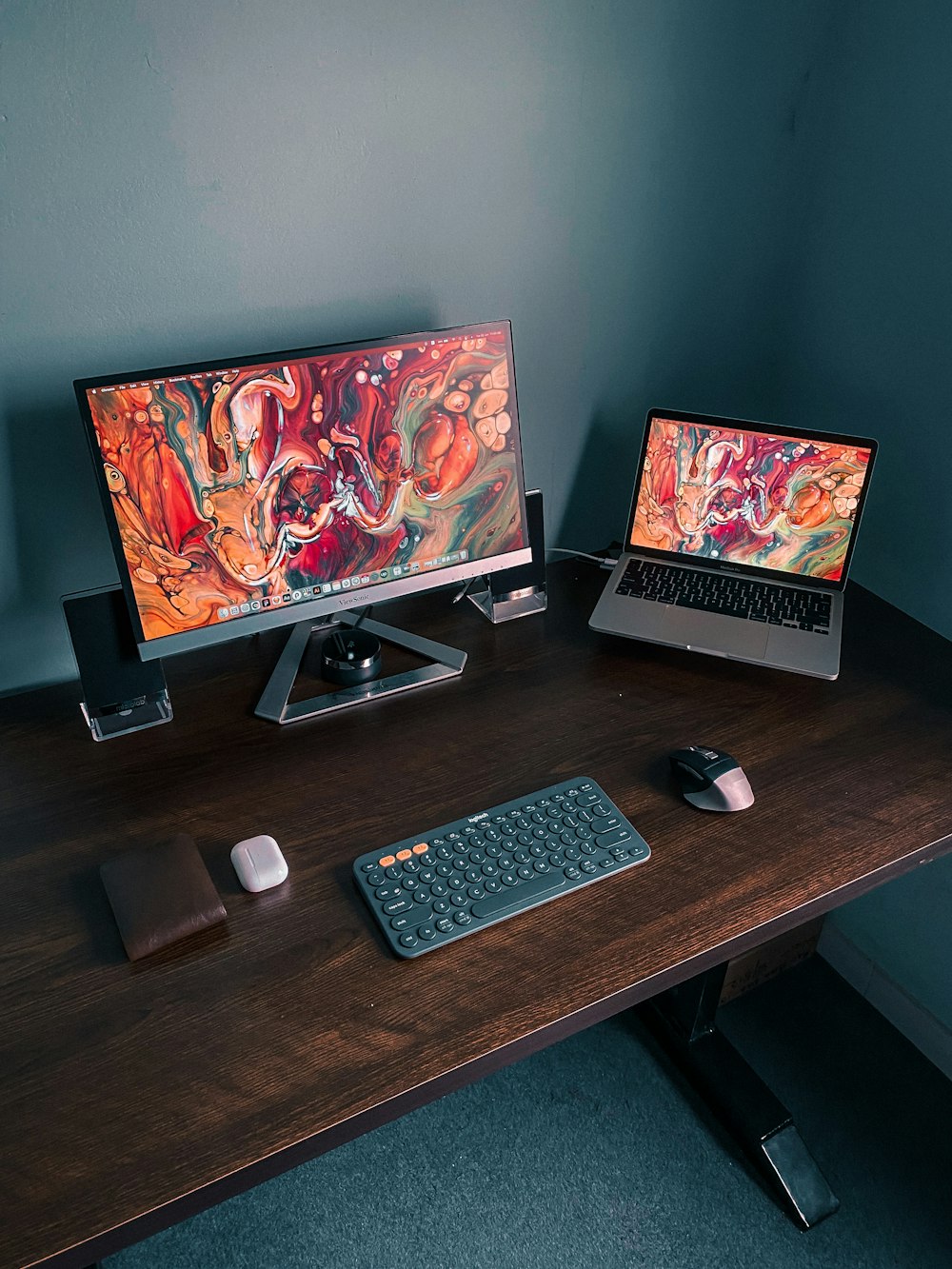 black flat screen computer monitor beside black computer keyboard and black computer mouse on brown wooden