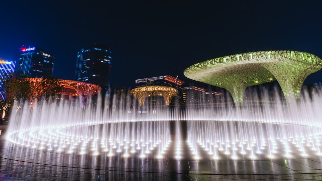 water fountain in the middle of the city during night time