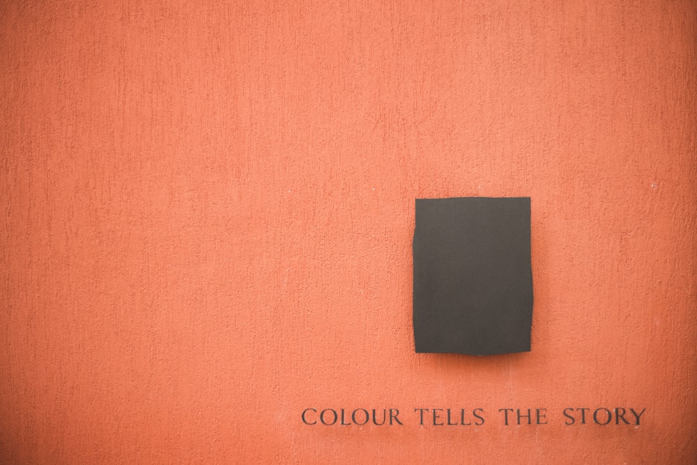 black square paper on orange textile