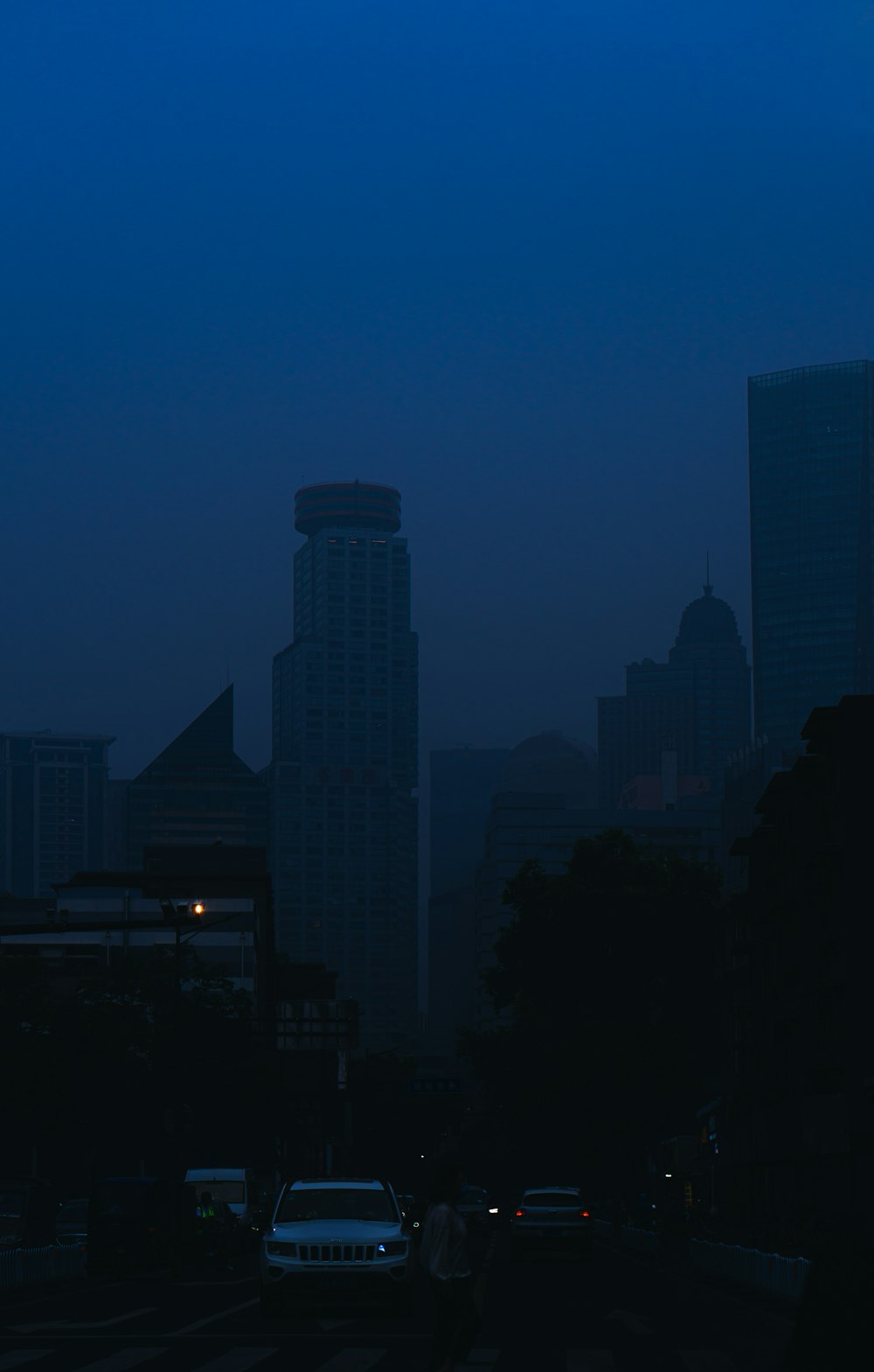 silhouette of city buildings during night time