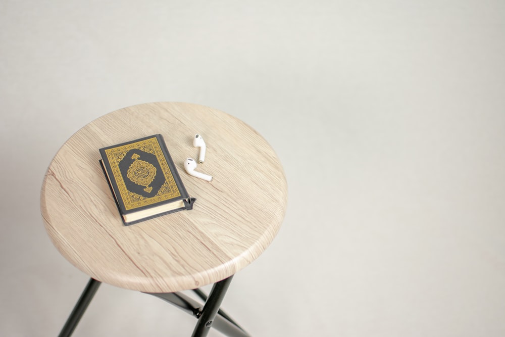 brown wooden round table with black and white card