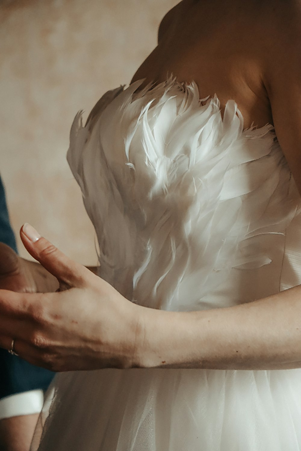 person holding white feather during daytime