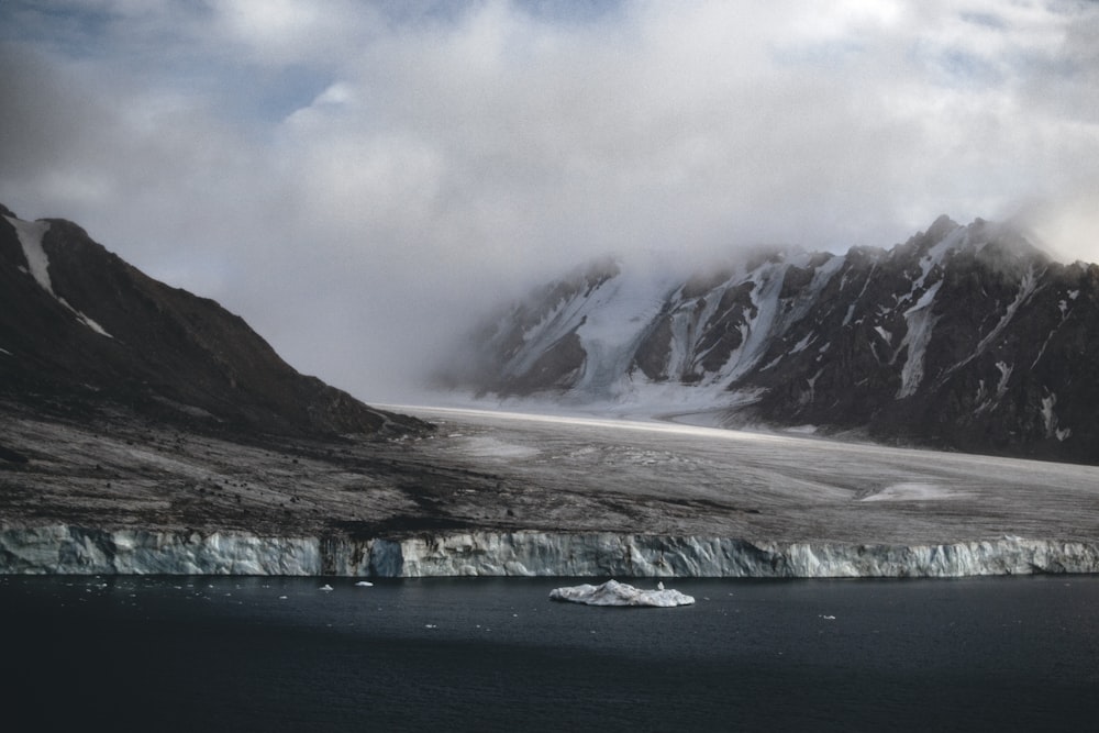 snow covered mountain under cloudy sky during daytime