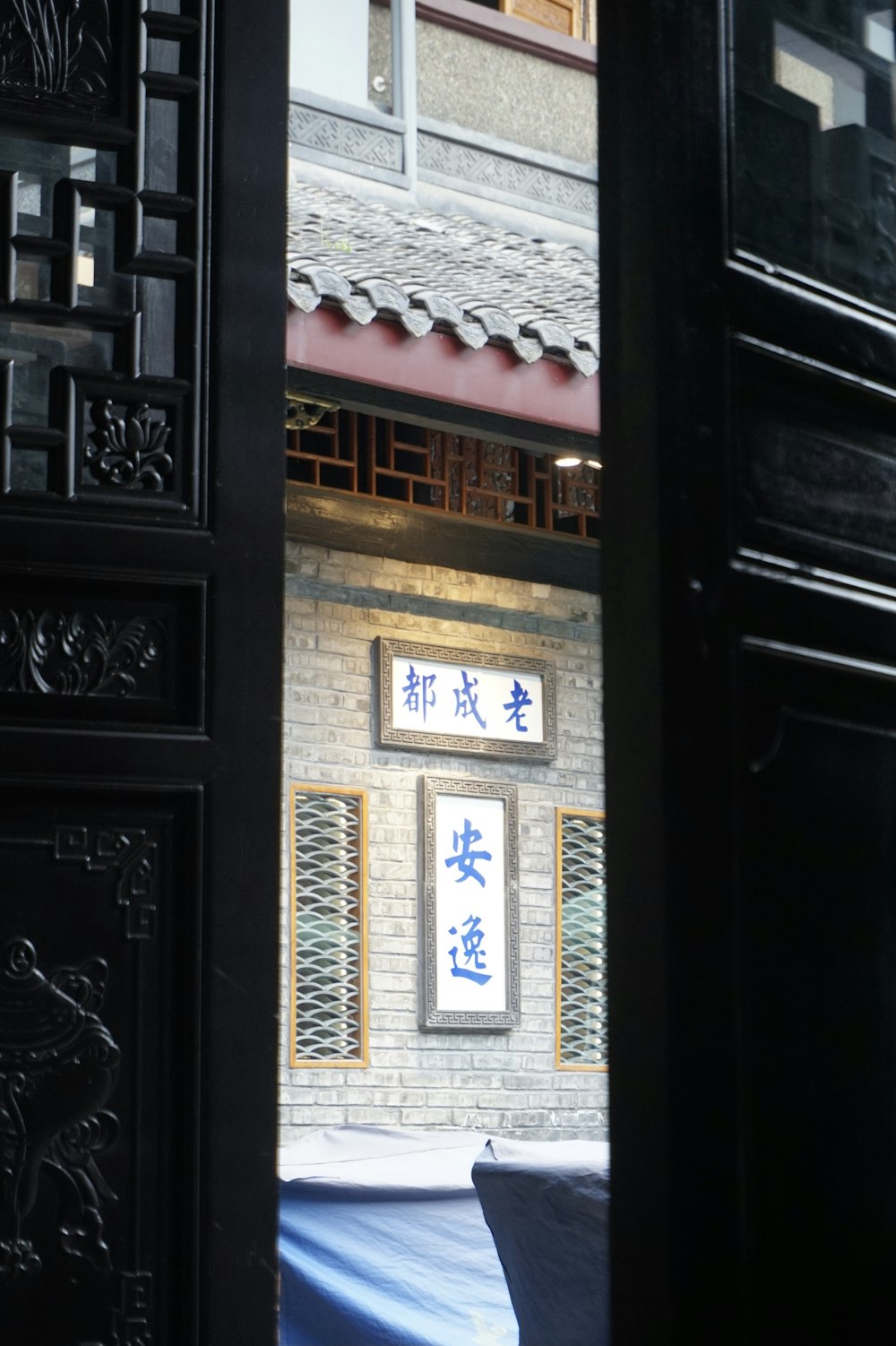 black wooden door with white and blue wall decor