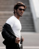 A person wearing a stylish t-shirt in an urban setting.