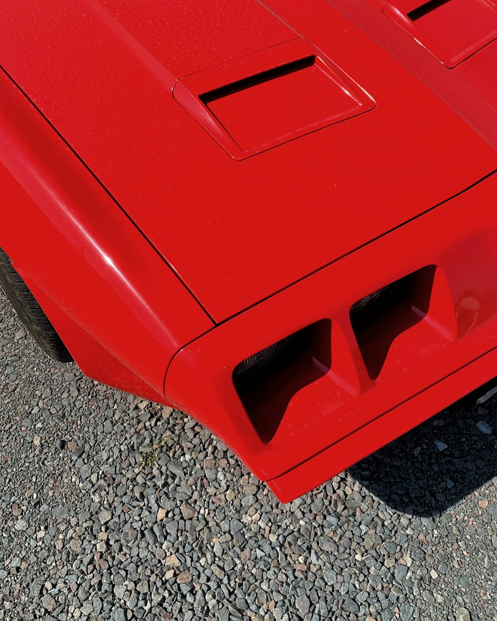 red car on gray and black granite floor